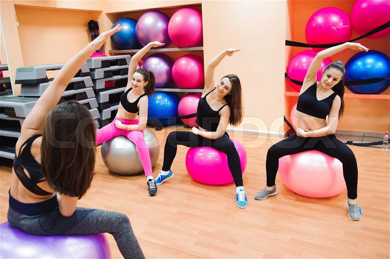 Women working out with exercise ball in gym. , stock photo
