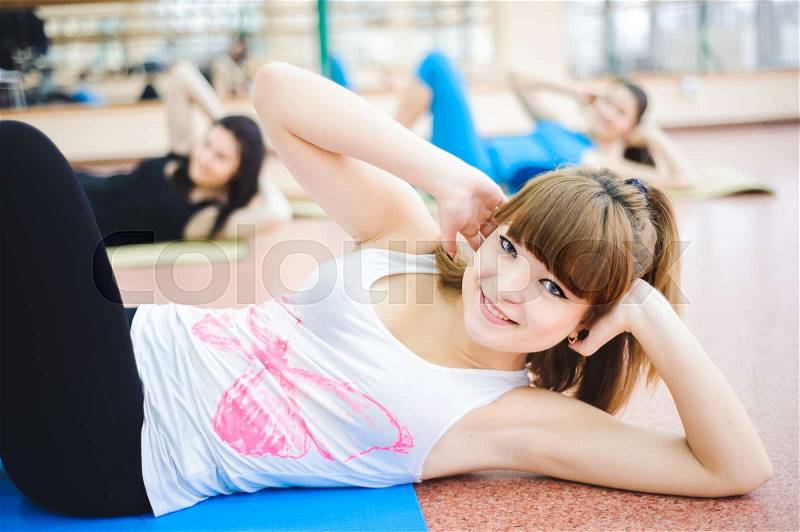 Group of people at the gym in the stretching class, stock photo