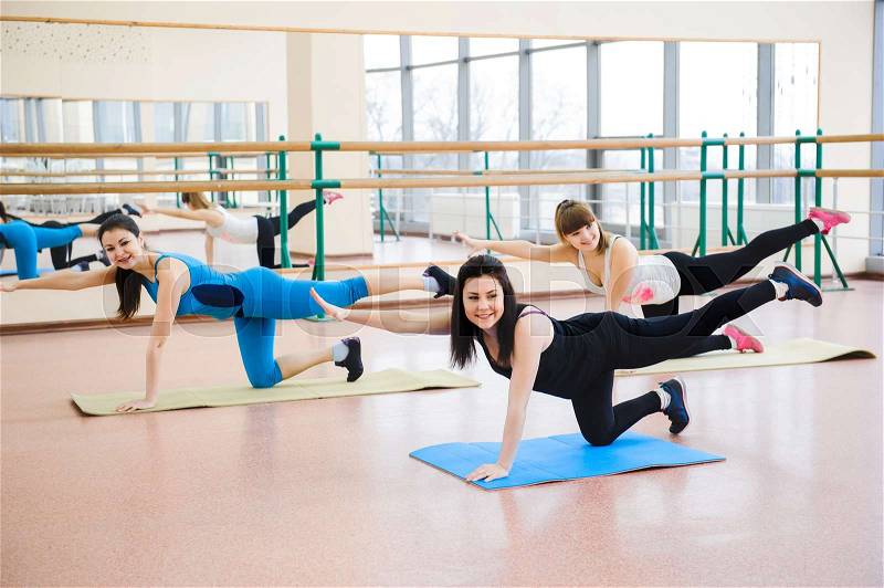 Group of people at the gym in the stretching class, stock photo