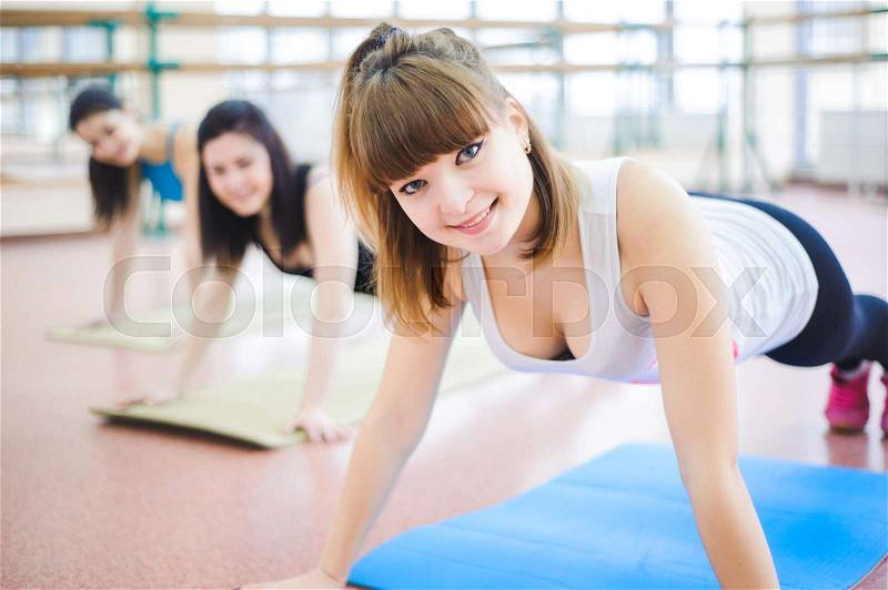 Group of people at the gym in a stretching class, stock photo
