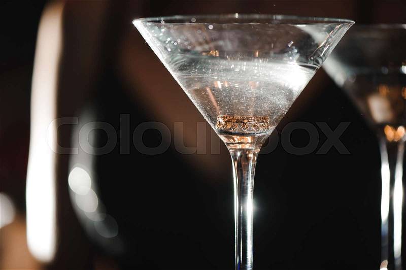 A martini glass with a ring inside, stock photo