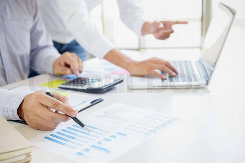 Business adviser analyzing financial figures denoting the progress Internal Revenue Service checking document. Audit concept, stock photo