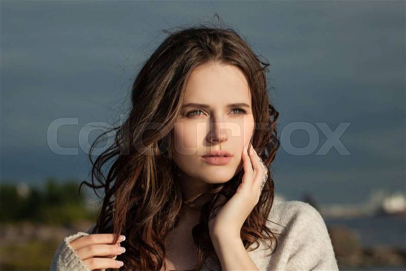 Nice woman outdoor portrait on nature landscape background, stock photo