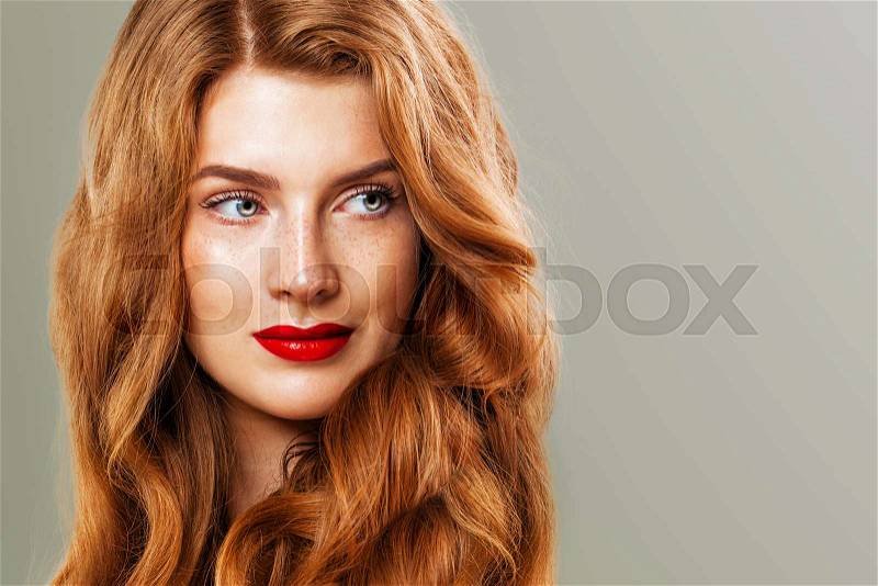 Red head woman with freckles and ginger hair. Natural redhead girl, beautiful female model face closeup, stock photo
