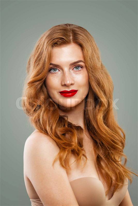Elegant red head woman. Perfect red haired girl with long curly hairstyle portrait, stock photo