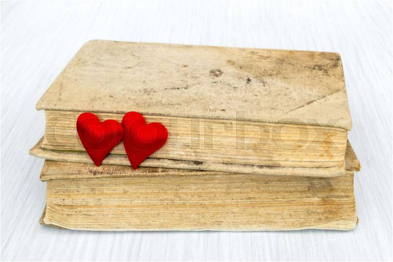 Old books and two red hearts. Book love concept.Valentine\'s day concept, stock photo