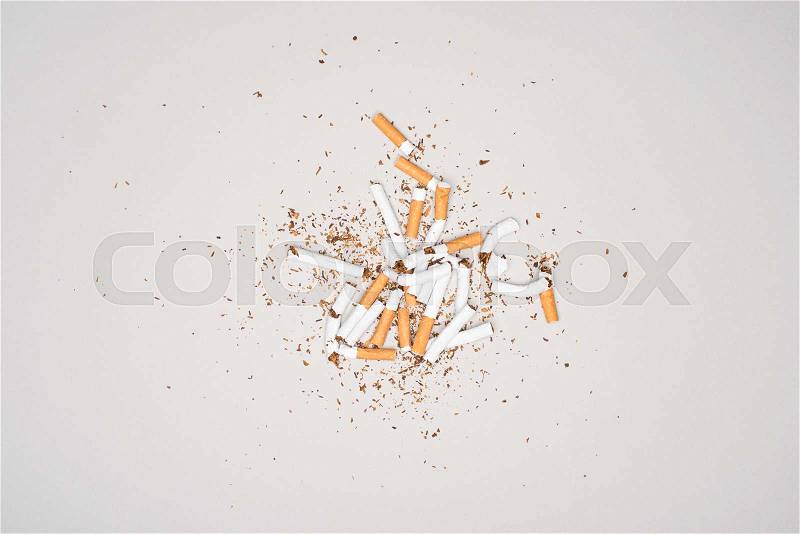 Top view of broken cigarettes isolated on grey, stop smoking concept, stock photo
