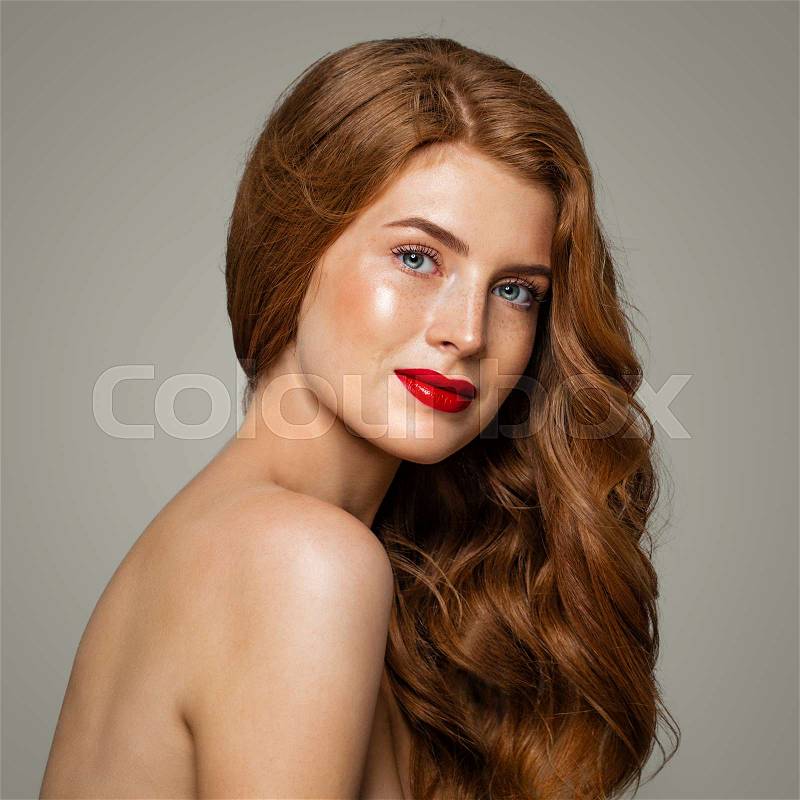 Beautiful red head woman portrait. Red head girl with ginger curly hairstyle, stock photo