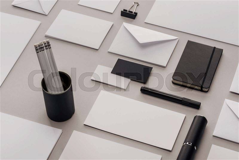 Flat lay with envelopes, cards, pencils, notebook, case, paper clip and marker , stock photo