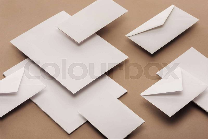 Flat lay with white envelopes, cards and sheets of paper , stock photo