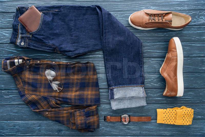 Top view of trendy men\'s clothing, shoes and accessories on wooden background, stock photo