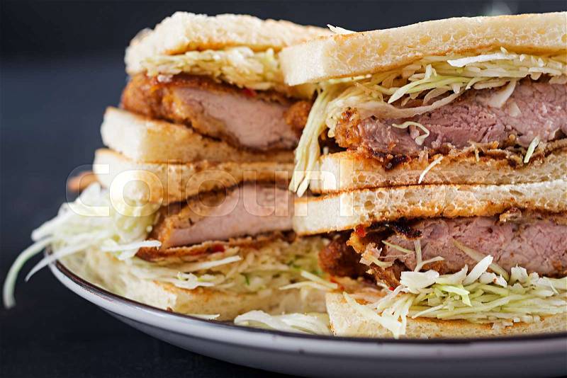 Katsu Sando - food trend japanese sandwich with breaded pork chop, cabbage and tonkatsu sauce. Japanese cuisine, stock photo