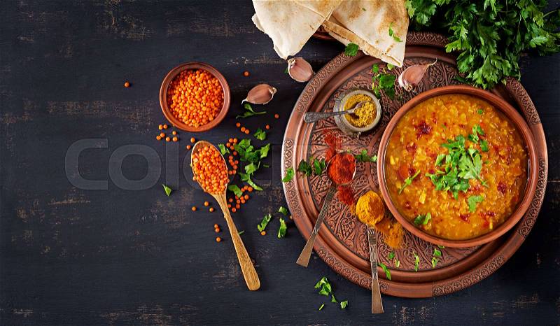 Indian dal. Food. Traditional Indian soup lentils. Indian Dhal spicy curry in bowl, spices, herbs, rustic black wooden background. Top view. Authentic Indian dish. ..., stock photo