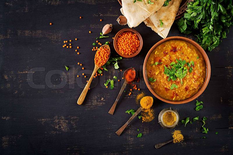 Indian dal. Food. Traditional Indian soup lentils. Indian Dhal spicy curry in bowl, spices, herbs, rustic black wooden background. Top view. Authentic Indian dish. ..., stock photo