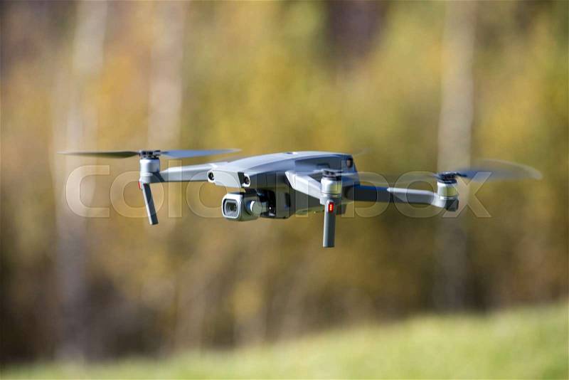 The drone copter flying with digital camera, stock photo