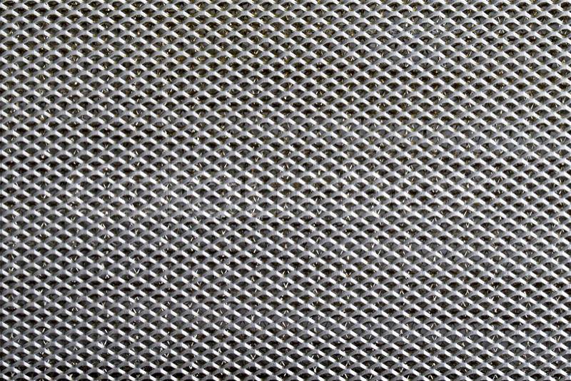 Background sheet of metal covered with lines of circular holes, stock photo