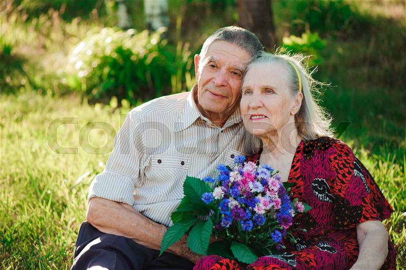 Beautiful happy eighty years old people sitting in the park, stock photo