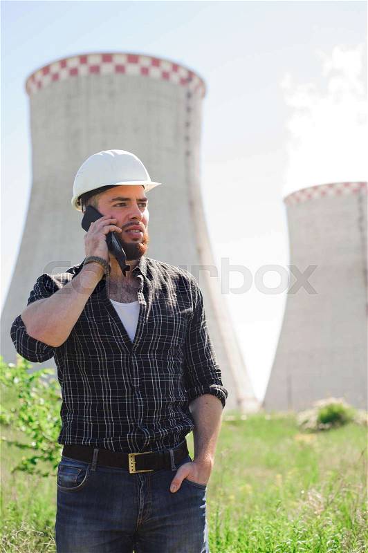 Professional electrician engineer in a white helmet in the workplace, stock photo
