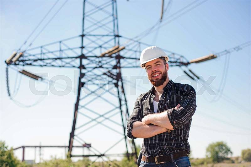Engineer with white hard hat under the power lines.Engineer work at an electrical substation, stock photo