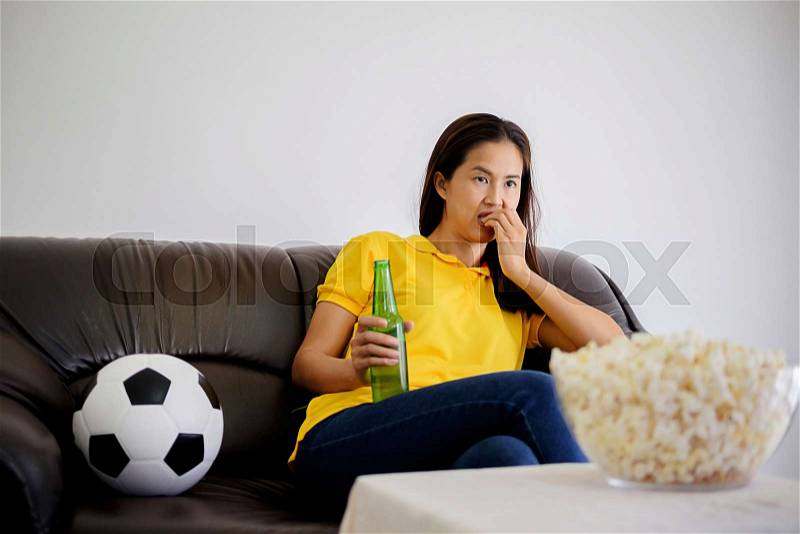 People watch soccer. Asian football supporters watching soccer on television at home with fun or disappoint emoticon, stock photo