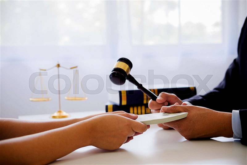 Lawyer businessman in suit hides money. A bribe in the form of dollar bills, stock photo