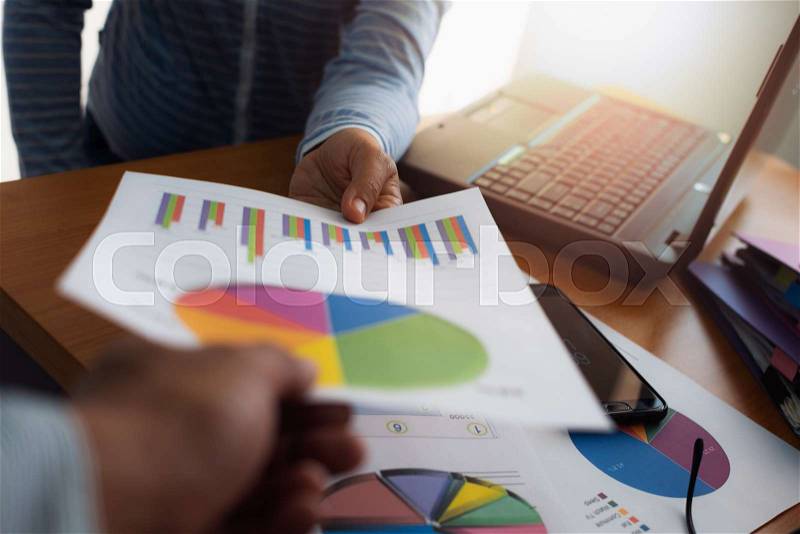 Colleagues submitted trade data chart document to each other. Business and Office life concept, stock photo