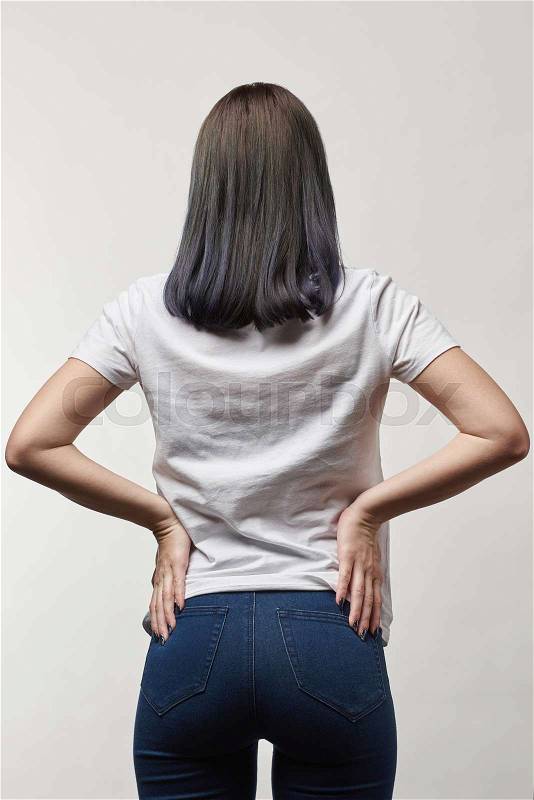 Back view of young woman in white t-shirt with copy space isolated on white, stock photo