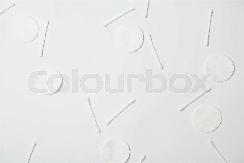 Top view of cosmetic pads and cotton sticks on white background, stock photo