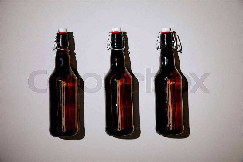 Brown bottles with beer on white background, stock photo