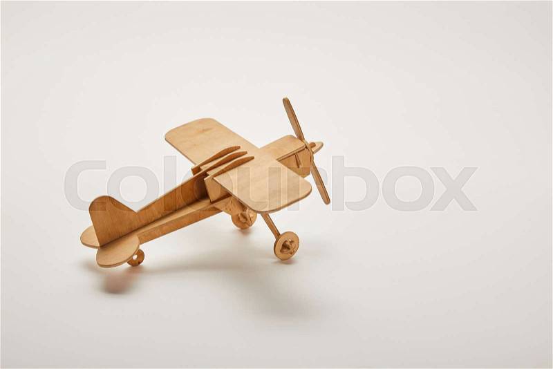 Toy plane on grey background with copy space, stock photo