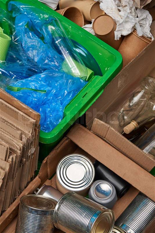 Sorted trash of cardboard, glass and plastic bottles, polyethylene, cups, iron cans, stock photo