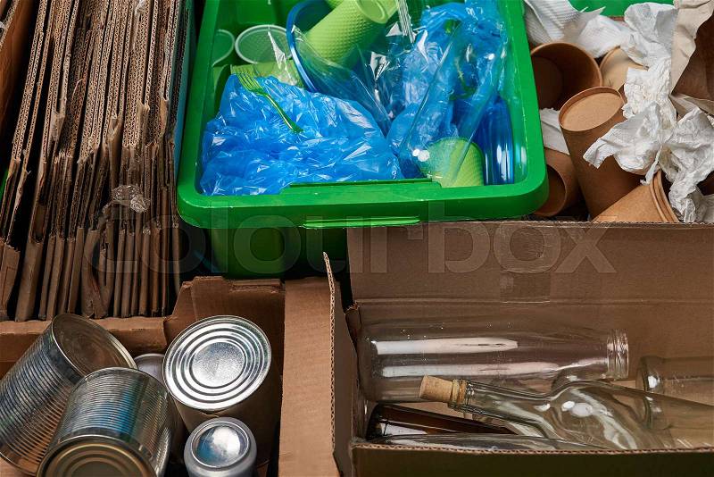 Sorted trash of cardboard, glass and plastic bottles, polyethylene, cups, paper, iron cans, stock photo