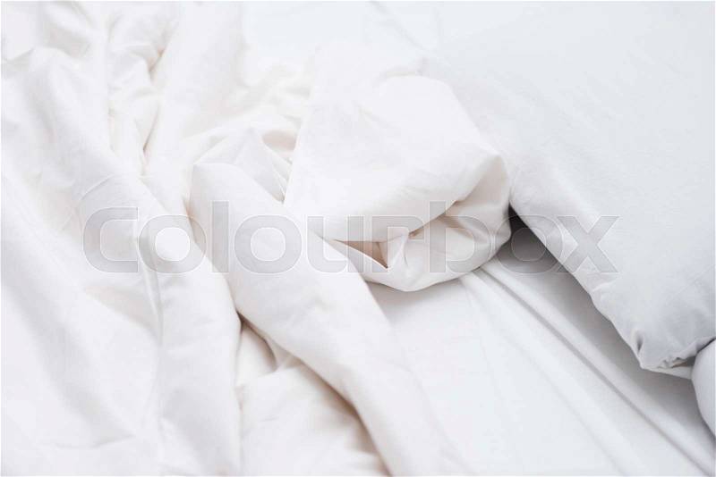 Close up of bed with white sheets and blanket , stock photo