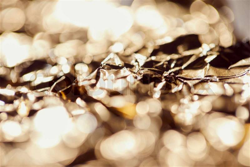 Selrctive focus of foil with sparkling lights and twinkles, stock photo
