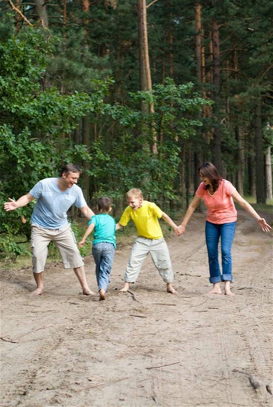 Family walking in the forest, stock photo