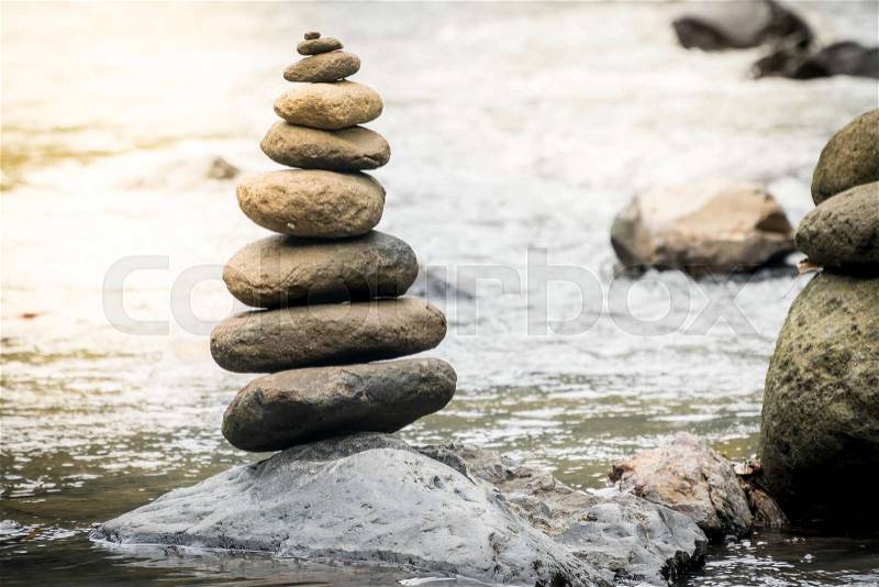 Balancing stones on a river rocks. Stability concept in a turbulence world , stock photo