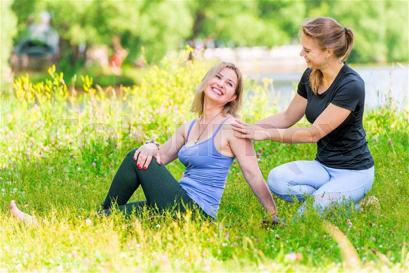 Mature woman with coach relax in the park after training, joking and laughing , stock photo