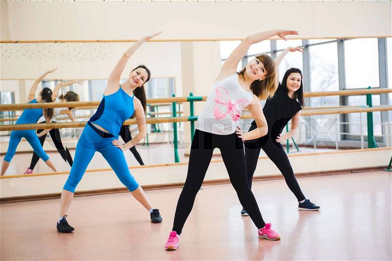 Group of people at the gym in a stretching class, stock photo