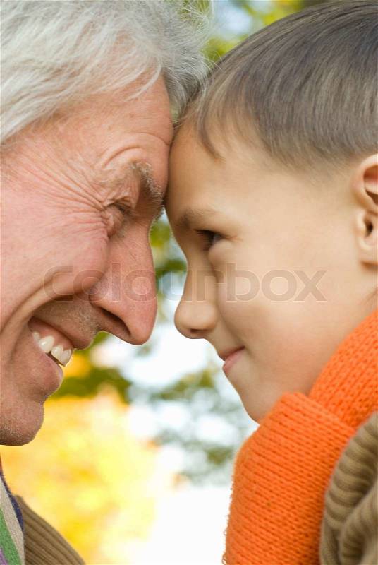 Grandfather keeps his grandson, stock photo