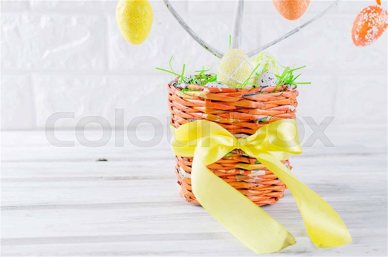Colorful easter felt toys and eggs on tree branches in pot as easter decorations close up, holiday concept, copy space, stock photo