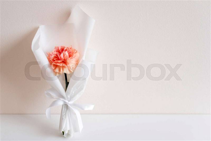 Spring flowers. Fresh bouquet with carnation in minimal style on light background. Top view, spring flat lay with copyspace for text. Love and gift concept, stock photo