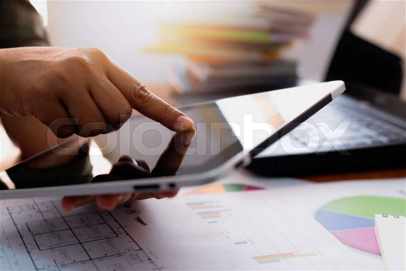 Hands of woman using tablet on working desk in office. Business and Technology concept, stock photo