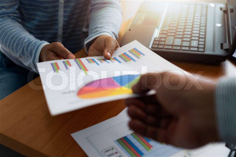 Colleagues submitted trade data chart document to each other. Business and Office life concept, stock photo
