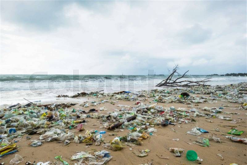Garbage on beach, environmental pollution in Bali Indonesia. Drops of water are on camera lens. Dramatic view, stock photo