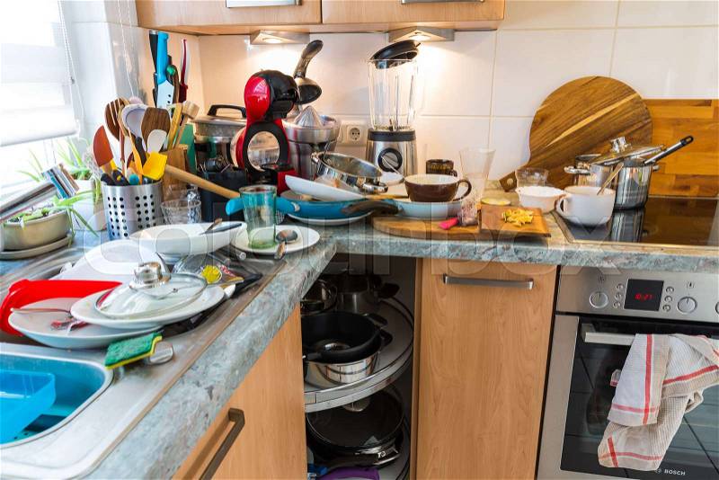 Compulsive Hoarding Syndrom - messy kitchen with pile of dirty dishes, stock photo