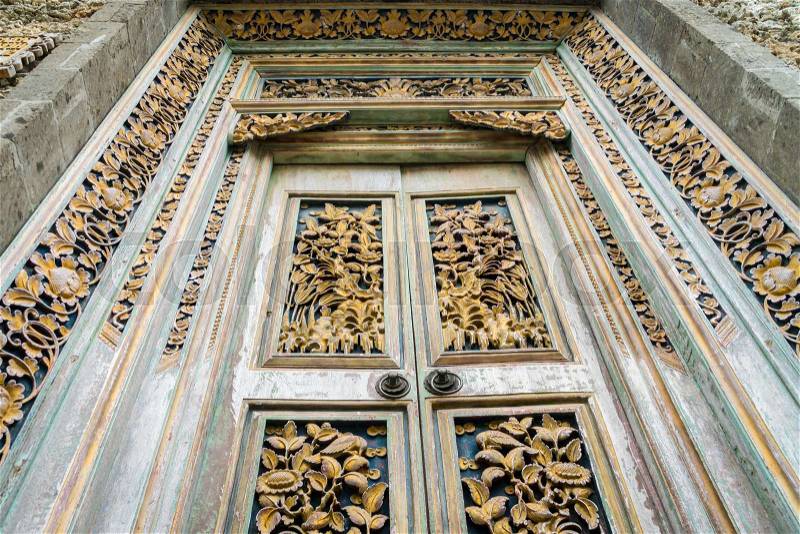 Balinese wood carved doors with traditional local ornaments. Local traditions and craftmanship concept, stock photo