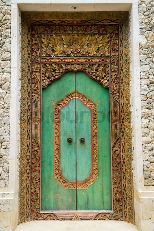 Balinese wood carved doors with traditional local ornaments. Local traditions and craftmanship concept, stock photo