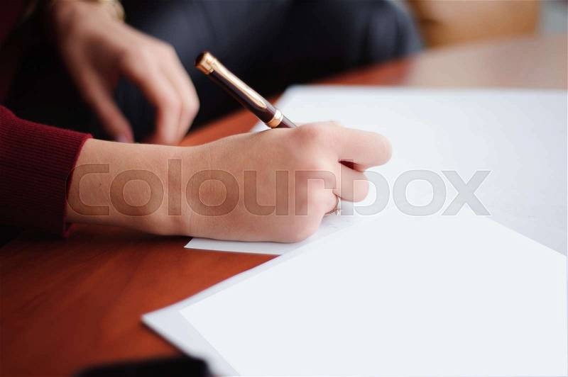 Young businesswoman working with papers. Close up, stock photo