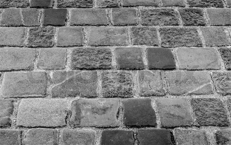 Granite cobblestoned pavement background. Stone pavement texture, stock photo