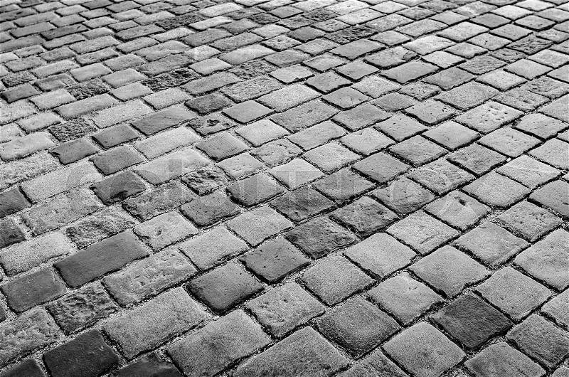 Granite cobblestoned pavement background. Stone pavement texture, stock photo